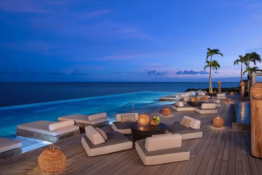 Ultra-luxury resort rooftop with infinity pool at twilight